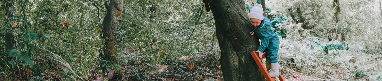 Grass & Air børn i farverigt regntøj og gummistøvler udendørs